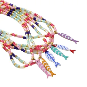 Colorful beaded necklace with striped fish pendants in vibrant enamel finish