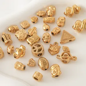 Detailed view of gold-plated stainless steel charms with skull and music note designs