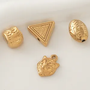 Macro view of gold-plated stainless steel animal and geometric DIY jewelry charms.