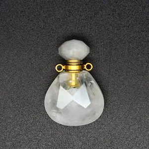Detailed view of faceted clear natural stone perfume bottle pendant with gold metal loops
