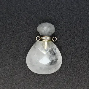 Macro detail view of faceted clear crystal teardrop perfume bottle pendant diffuser