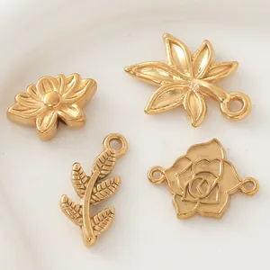 Detailed macro shot of gold-plated stainless steel flower and leaf charms for jewelry DIY.