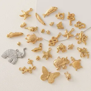 Detailed view of 18K gold-plated stainless steel animal charms for DIY jewelry creation.