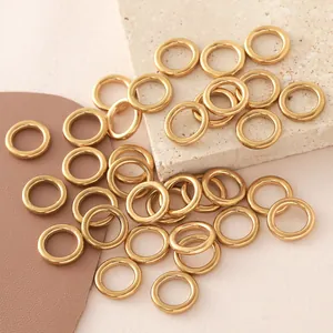 Close-up of golden stainless steel seamless O-rings for DIY jewelry making on stone slab