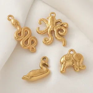 Detail of 18K gold plated animal charms including snake, octopus, swan, and elephant
