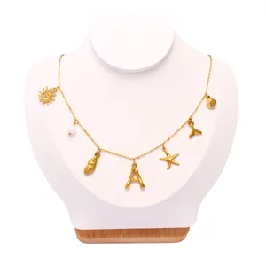 Detailed view of 18k gold plated stainless steel necklace with ocean themed charms