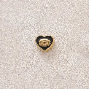 Exquisite heart-shaped gold-plated pendant with black enamel inlay and evil eye design