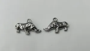 Close-up view of two polished silver stainless steel rhinoceros charms for DIY jewelry