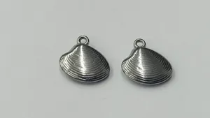 Close-up of polished stainless steel shell pendants for DIY jewelry making projects.