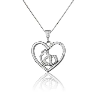 Close-up of heart-shaped pendant necklace featuring shimmering zircons and bird details