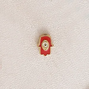 Gold-plated stainless steel Hamsa Hand charm with red enamel and evil eye detail for DIY jewelry.