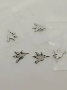 Detailed view of polished stainless steel hummingbird charms for DIY jewelry making.