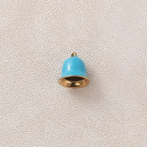 Detail view of a sky blue enamel bell pendant with gold plated interior for DIY jewelry