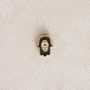 Gold plated stainless steel Hamsa hand charm with black enamel and evil eye detail
