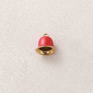 Macro view of a red enamel and gold-plated bell pendant for DIY jewelry making projects
