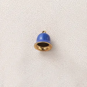 Detailed macro view of a blue and gold bell charm pendant for DIY jewelry making