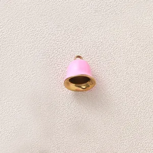 Close-up of a pink enamel bell pendant with gold-plated interior for DIY jewelry