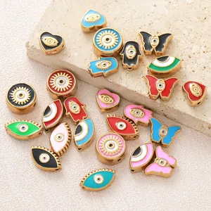 Macro detail of colorful evil eye beads in heart and butterfly shapes for DIY jewelry