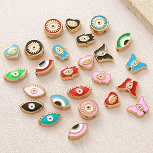 Diverse collection of gold-plated evil eye, heart, and butterfly enamel beads for DIY jewelry making