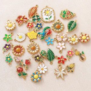 Detailed close-up of colorful enamel flower and daisy pendant charms for DIY jewelry.
