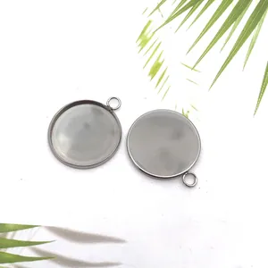 Detailed view of two stainless steel round pendant base bezel trays for DIY jewelry