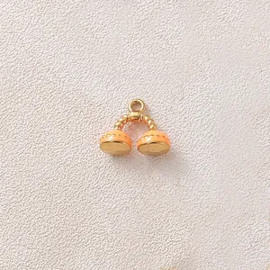 Detail view of a gold-plated stainless steel telephone pendant with orange enamel drip oil