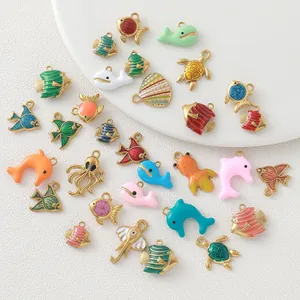 Colorful gold-plated ocean charms featuring fish, turtles, and dolphins for DIY jewelry