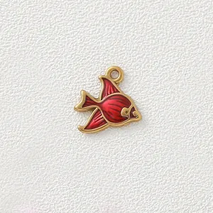 Close-up detail of gold-plated stainless steel fish charm with vibrant red enamel finish