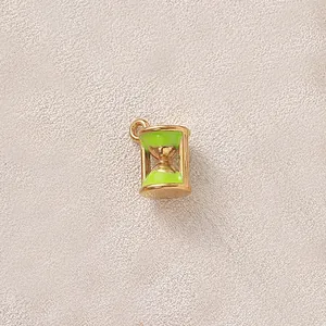 Detailed close-up of a gold-plated stainless steel hourglass charm with green enamel