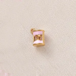 Close-up of pink enamel hourglass pendant with gold-plated finish for DIY jewelry