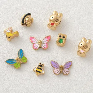 Close-up of 18K gold plated enamel butterfly and bee charms for DIY jewelry