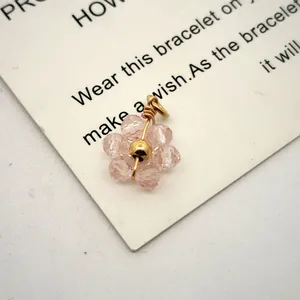 Macro view of pink crystal flower pendant with gold-plated stainless steel wire detail