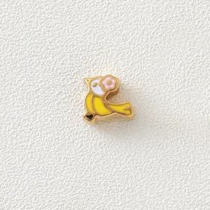 Detailed macro shot of a bird-shaped gold-plated enamel bead for DIY jewelry making