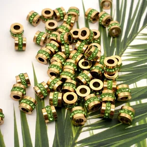 Close-up of gold-plated stainless steel beads with green zircon for DIY jewelry accessories.