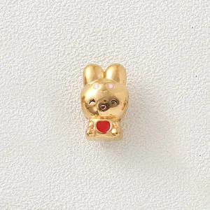 Detailed view of a gold-plated stainless steel rabbit charm with a red enamel heart