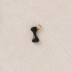 Detailed macro shot of a black enameled bone-shaped charm for DIY jewelry necklace
