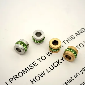 Close-up detail of stainless steel wheel beads with inlaid green zircon stones