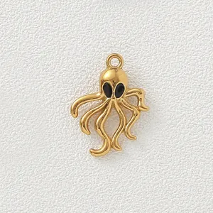 Close-up macro view of a gold-plated octopus pendant with black enamel eyes for jewelry