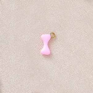 Detailed macro view of pink hourglass charm with gold plated loop for DIY necklaces