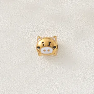 Macro view of a gold-plated stainless steel cartoon pig charm bead for DIY jewelry making