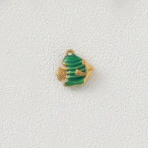 Detailed macro view of a gold-plated stainless steel tropical fish pendant with green enamel