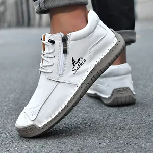 Close-up detail of white hand-stitched casual ankle boots with side zipper design