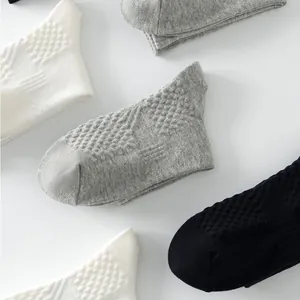 Close-up of men's breathable mesh boat socks in white, gray, and black basic colors.
