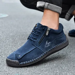 Detail of blue suede casual boot with hand-stitched seams and side zipper.