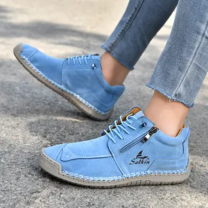 Detailed side view of blue hand-stitched casual shoes with zipper and Salkin logo