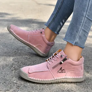 Detailed side view of pink handmade stitched casual boots with a functional side zipper