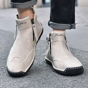 Detailed macro view of hand-stitched men's casual Martin boots featuring sturdy side zippers
