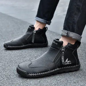 Close-up of black leather outdoor boots with side zipper and hand-stitched detailing