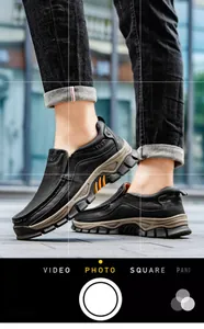 Close-up of men's black leather casual outdoor shoes with durable rubber soles
