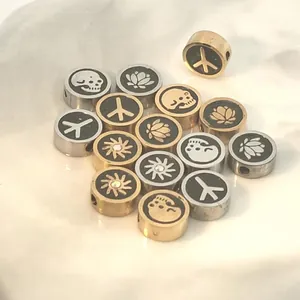 Detailed close-up of stainless steel beads featuring skull, lotus, and sun motifs in gold and silver.